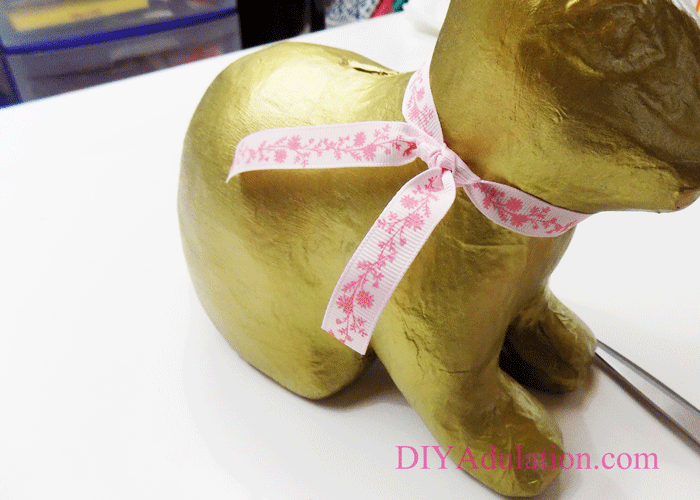 This easy DIY golden bunny bank is a gorgeous addition to your Easter décor. Find out how it can also make your Easter day easier!