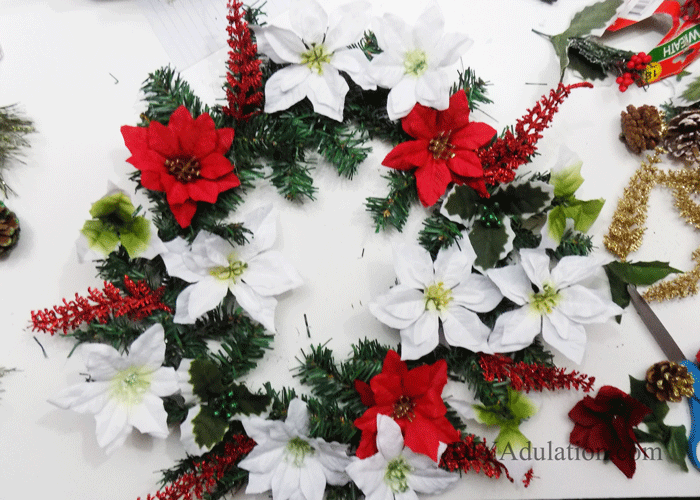 Get your front door ready for the holidays with this DIY glittery Merry Christmas floral wreath that proves gorgeous decor doesn't have to blow your budget!