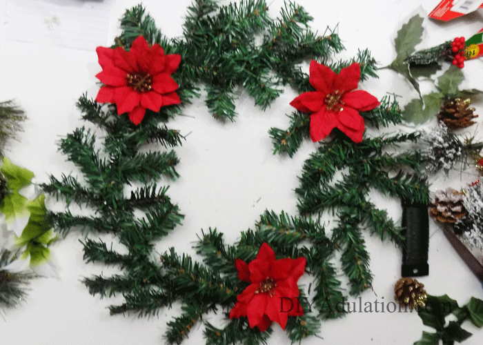 Get your front door ready for the holidays with this DIY glittery Merry Christmas floral wreath that proves gorgeous decor doesn't have to blow your budget!