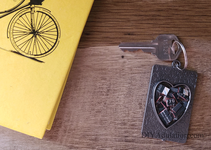 Heart Credit Card Keychain next to Yellow Notebook