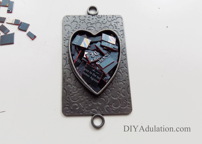 Cut up pieces of credit card inside heart pendant