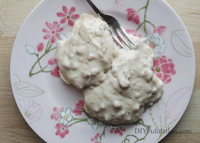 Plate of biscuits covered in sausage gravy