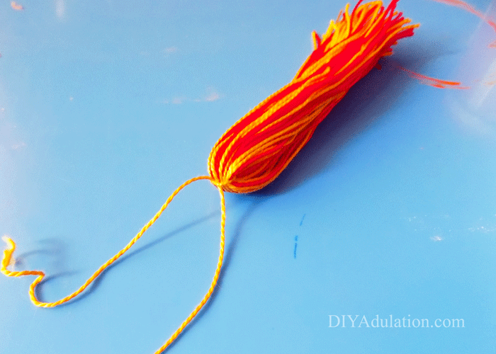 Red and yellow DMC floss tied with piece of yellow floss