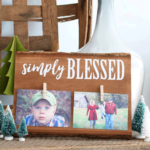 Wooden plank with 2 photos clipped at the bottom and the words Simply Blessed at the top