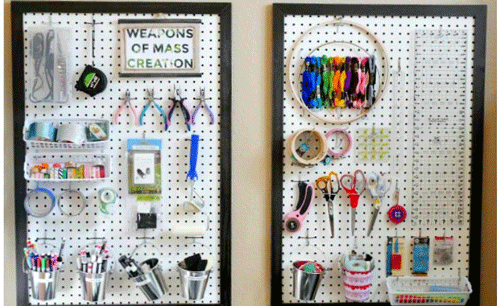 Giant framed pegboard with craft supplies organized on them