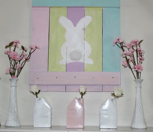 Pastel Bunny Pallet art on wall surrounded by vases with pink flowers