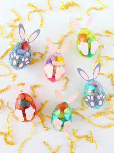 Clear Plastic Eggs Filled with candy and decorated to look like bunnies