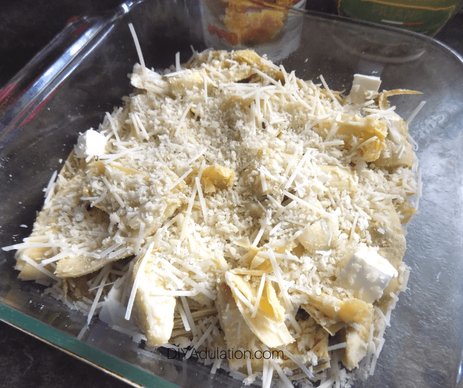 Bread Crumbs on Top of Cheese and Artichoke Mixture in Glass Baking Dish