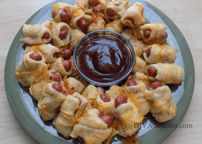 Plate of breaded little smokies around a small dish of barbecue sauce
