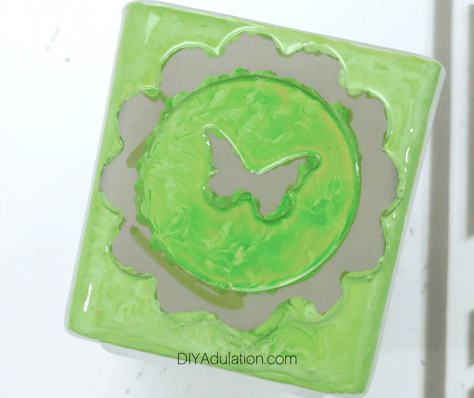 Close up of Green Paint on Masked Votive Holder