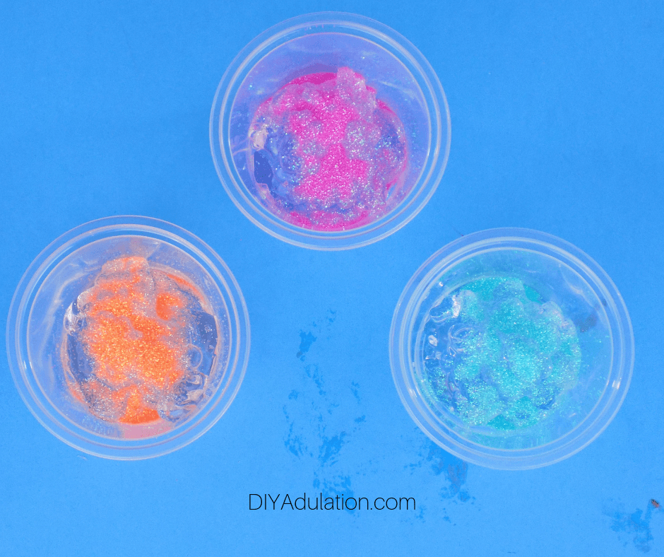 Glitter on Top of Clear Aloe Gel in Small Plastic Cups