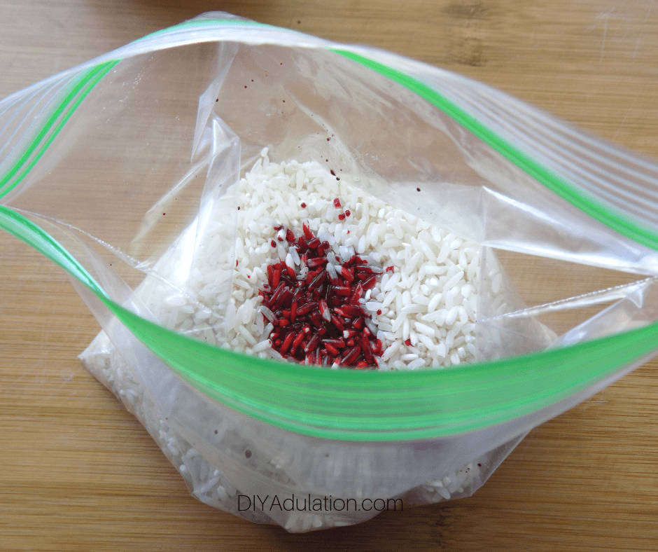 Red Food Coloring on White Rice in Plastic Bag