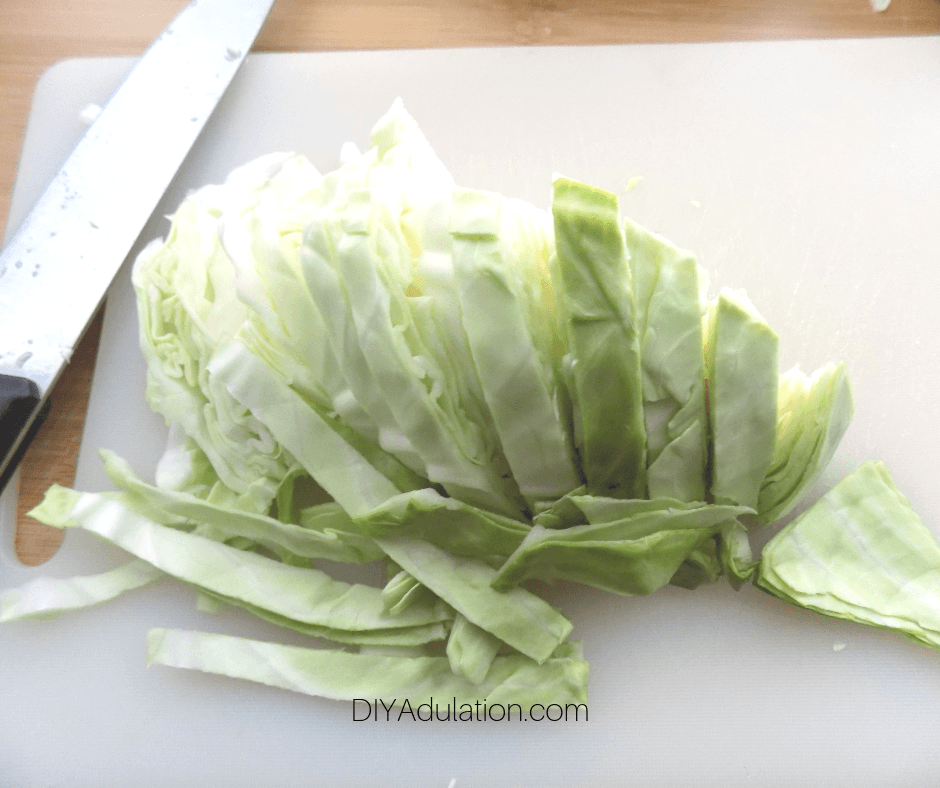Sliced Cabbage Next to Knife on Cutting Board