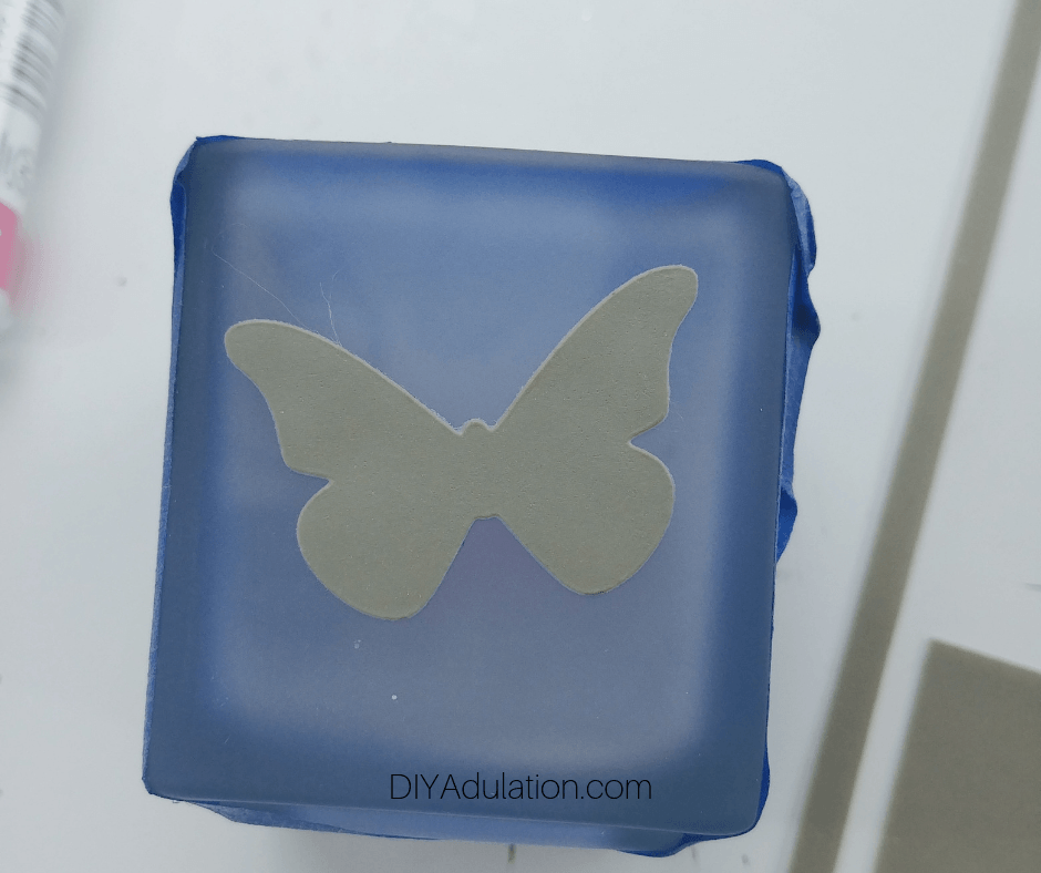 Tape Around Edges of Votive Holder with Butterfly Stencil Mask