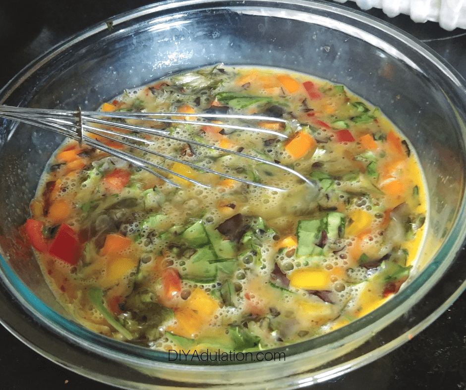 Veggies Mixed with Eggs in Glass Mixing Bowl