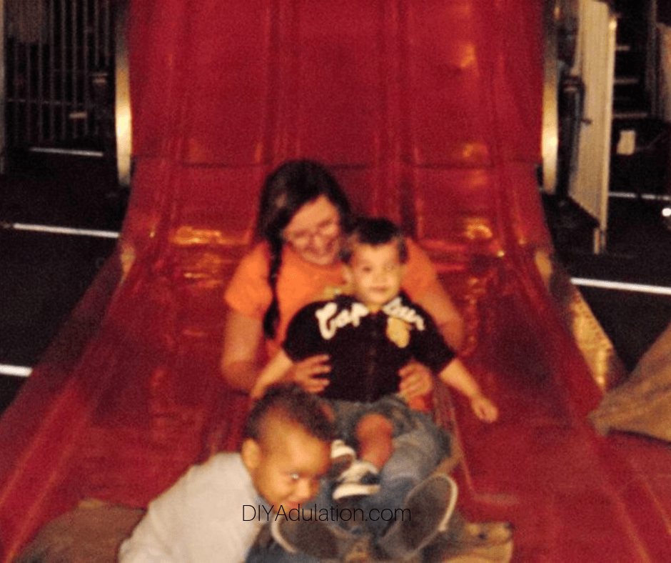 Woman Holding Child on Slide