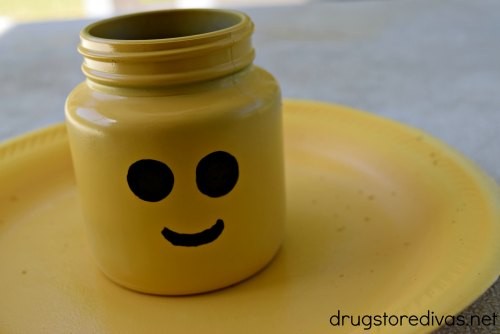 Lego head pencil holder on yellow plate