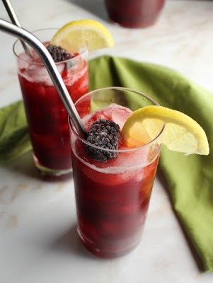 looking down on glasses of blackberry lemonade with stainless steel straws
