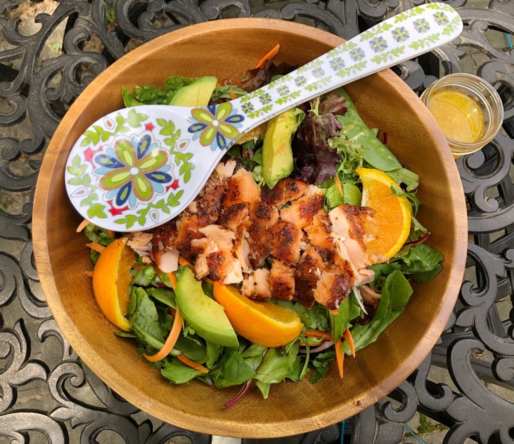 Orange Ginger Salmon Salad in bowl with serving spoon