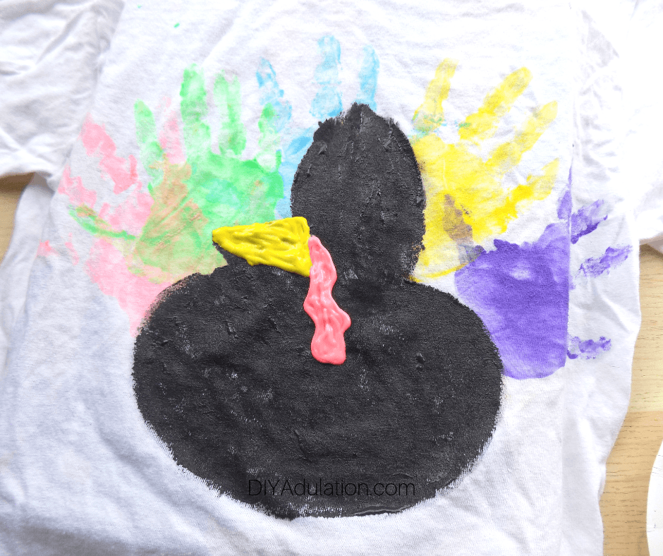 Black Turkey with Beak and Snood over Colorful Hand Prints on White T-Shirt