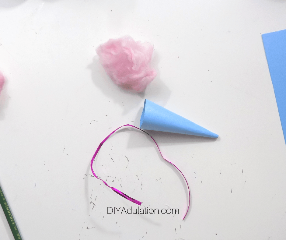 Cut Ribbon Next to Paper Cone and Pink Cotton Ball