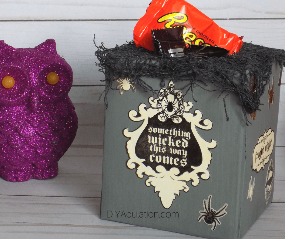 Halloween candy container next to purple owl
