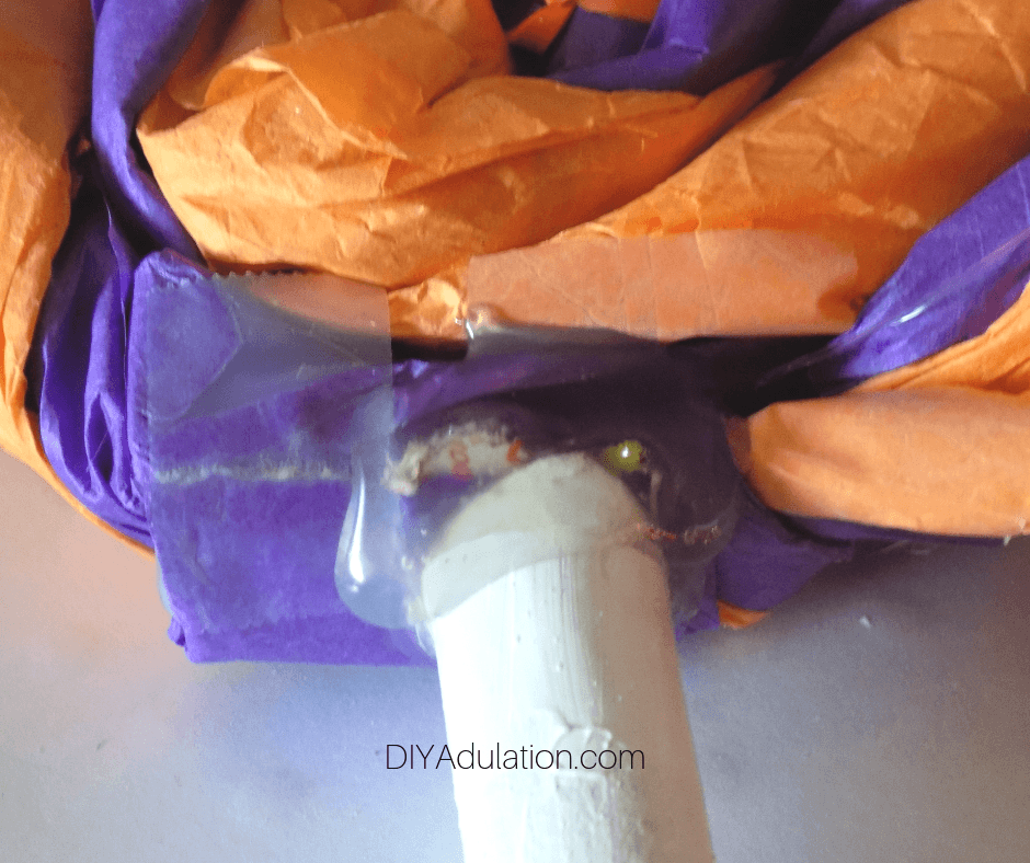 White Cardboard Tube Glued to Orange and Purple Tissue Paper Swirl