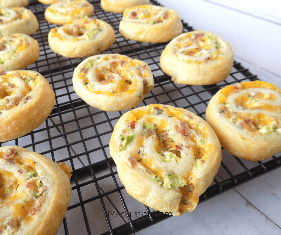 Close Up of Cheddar Bacon and Broccoli Pinwheels on Wire Rack