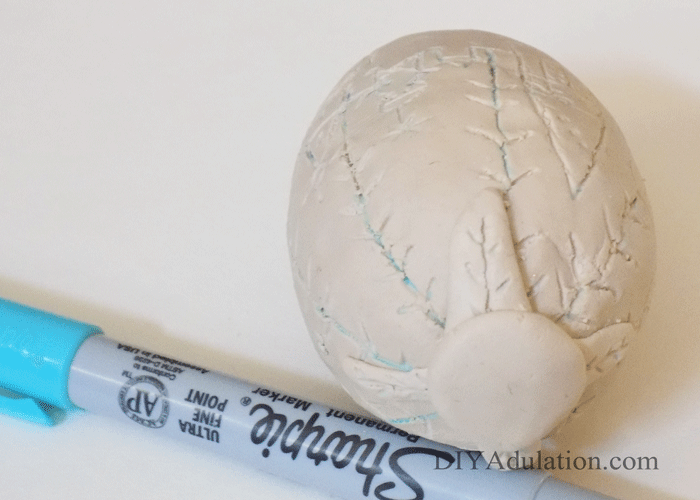 circle clay embellishment on clay covered egg